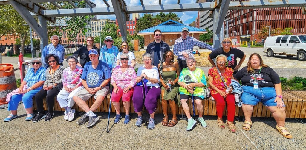 Seniors from Genesis Village sharing laughter and conversation on the Sandpiper boat outing