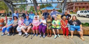 Seniors from Genesis Village sharing laughter and conversation on the Sandpiper boat outing